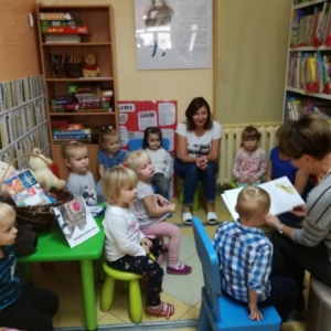 Czytająca bibliotekarka wśród przedszkolaków